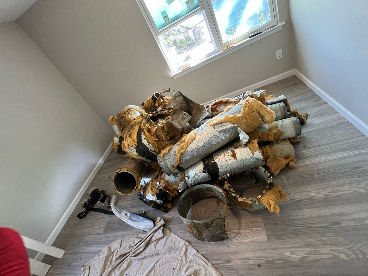 Old insulated ductwork removed from a residential home during a duct system replacement