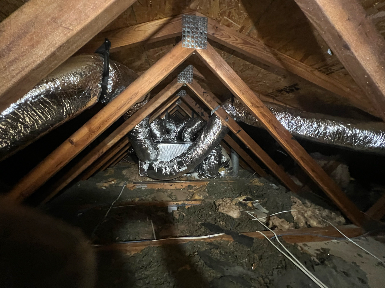 New insulated ductwork installed through the attic trusses of a residential home